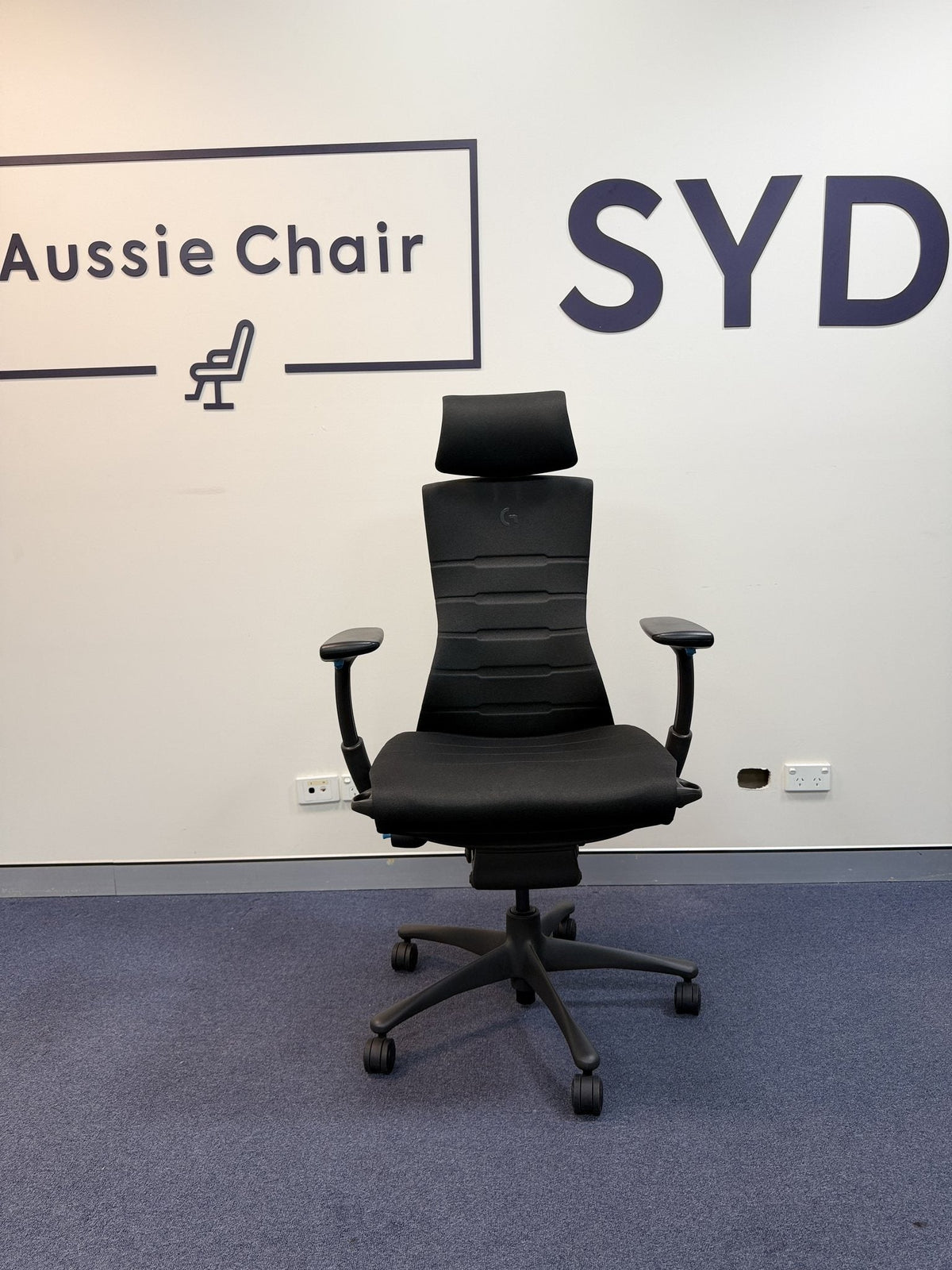 Herman Miller Embody Gaming in Black & Cyan with a third-party Atlas headrest, front view, Sydney showroom