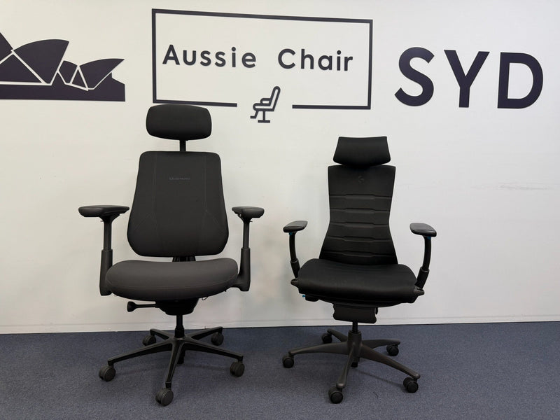A LiberNovo Omni in Space Grey beside a LiberNovo Maxis on the Aussie Chair Sydney showroom floor