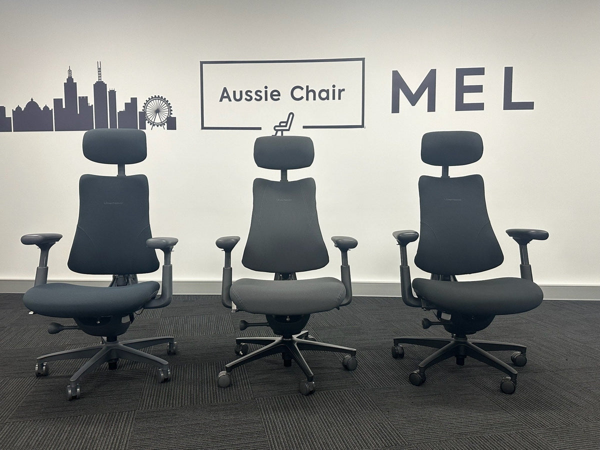 Three LiberNovo Omni-series chairs lined up on the Aussie Chair Melbourne showroom floor