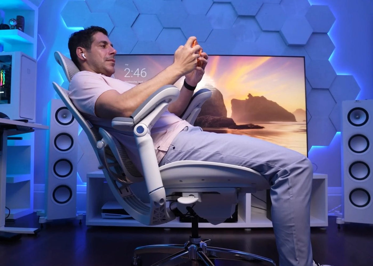 Gamer reclining in a Sihoo DORO-C300 Pro V2 chair in a blue-lit games room