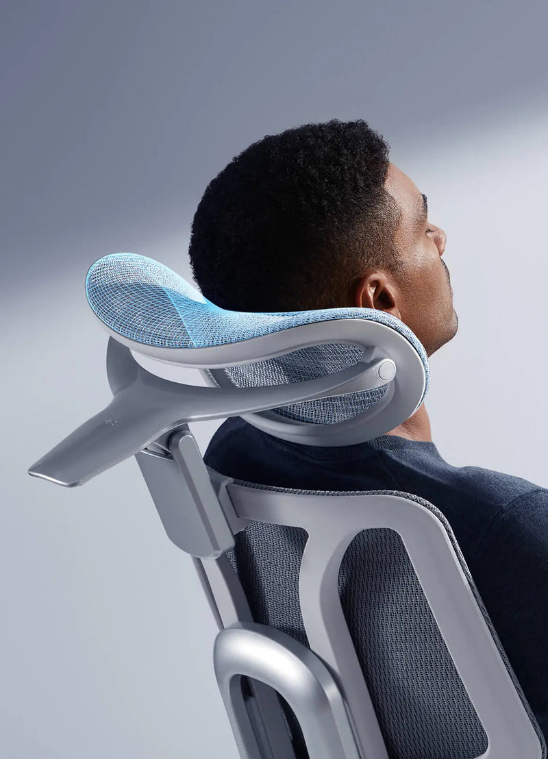 Man resting his neck on the HBADA E3 Pro 4D dual-axis headrest
