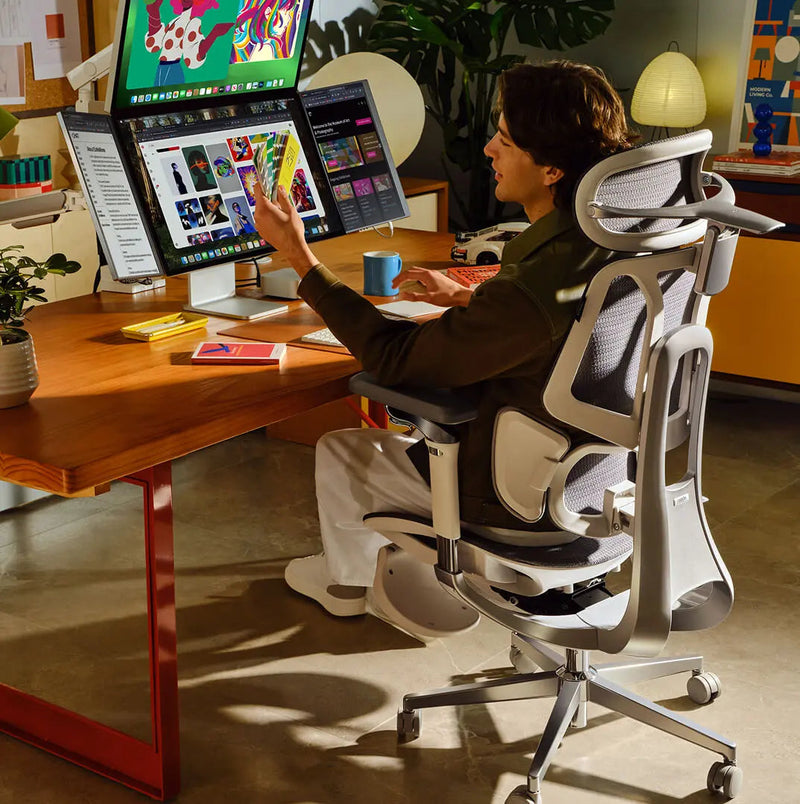 Designer working upright at 105 degrees in a grey HBADA E3 Pro