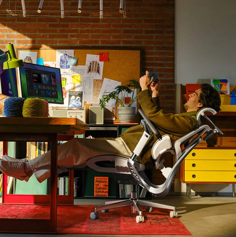 Man fully reclined at 140 degrees with legs up in the HBADA E3 Pro