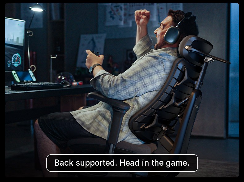 Gamer celebrating in a black HBADA T8 Max while the backrest supports his lower back