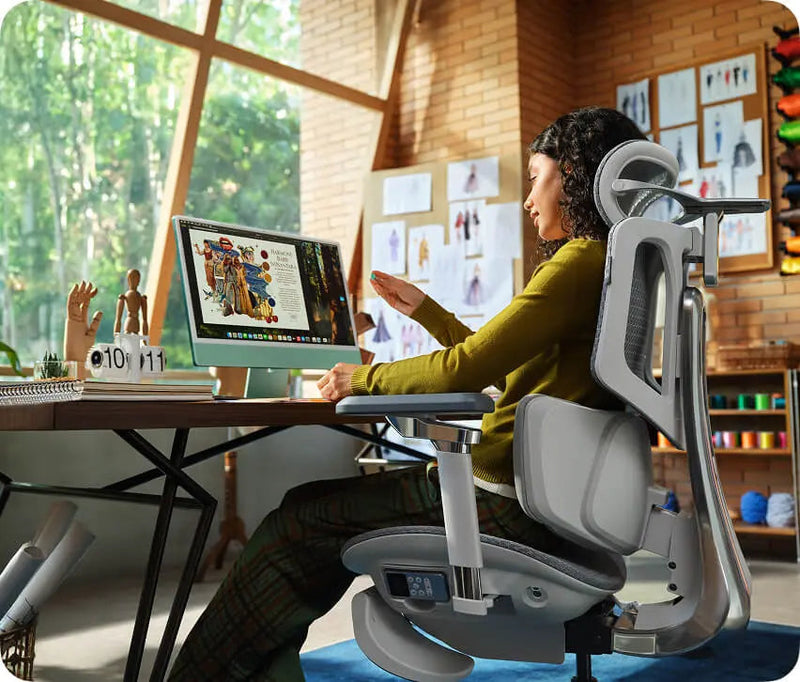 Graphic designer working at an iMac in the HBADA X7 in a sunny studio