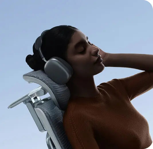 Woman reclining with her head resting on the HBADA X7 4D dual-axis headrest
